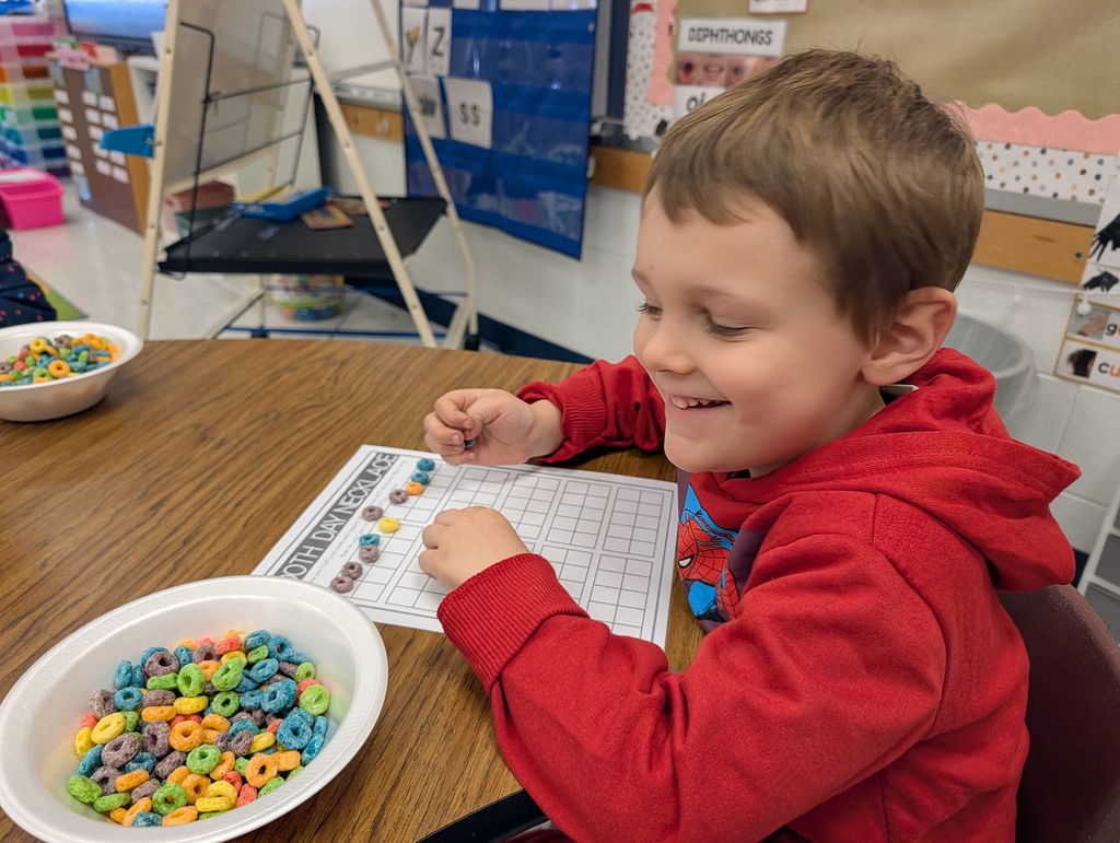 A student working on 100th day activities in his classroom.