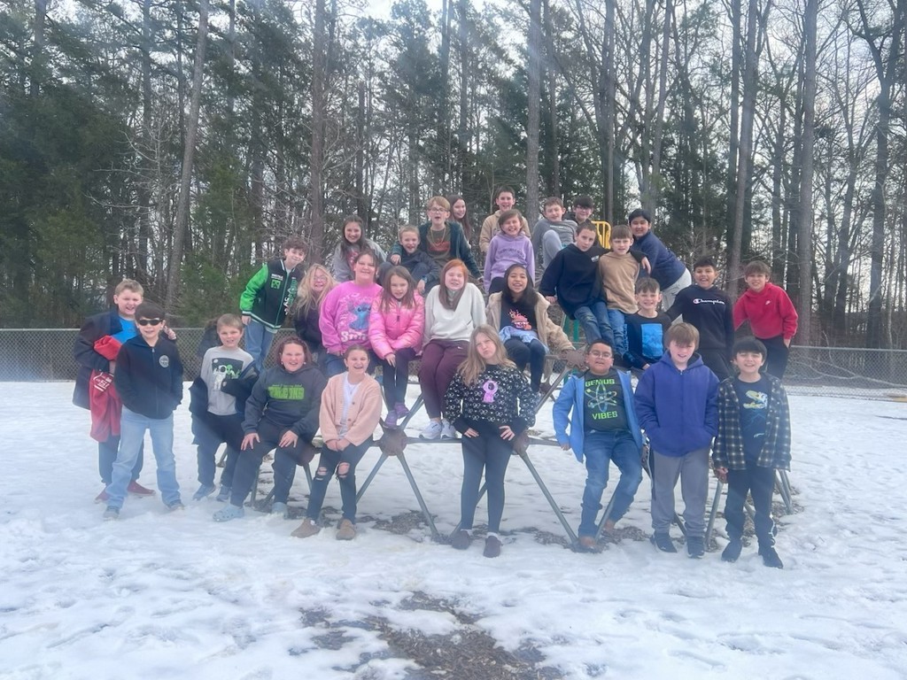 4th and 5th grade students standing outside in the snow on the 100th day of school.