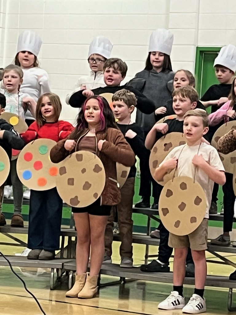 Students singing with cookie costumes.