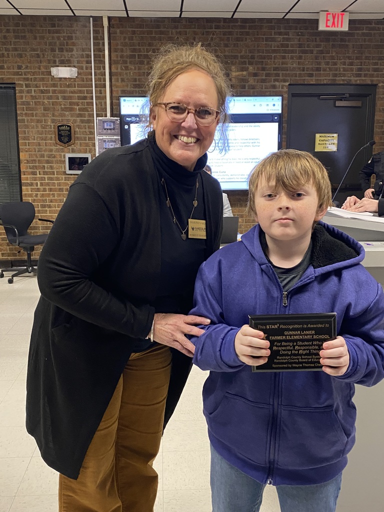 Gunnar standing with his award and board member Sharon Farlow