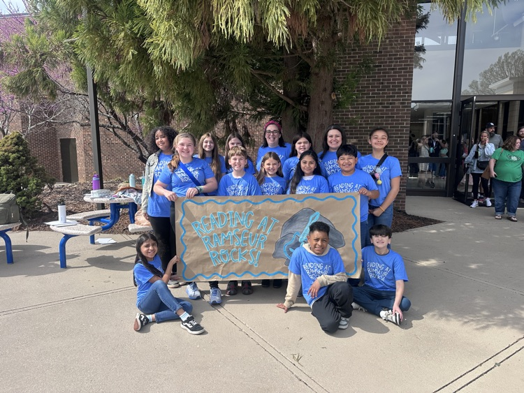 13 kids and 2 adults behind a sign! 