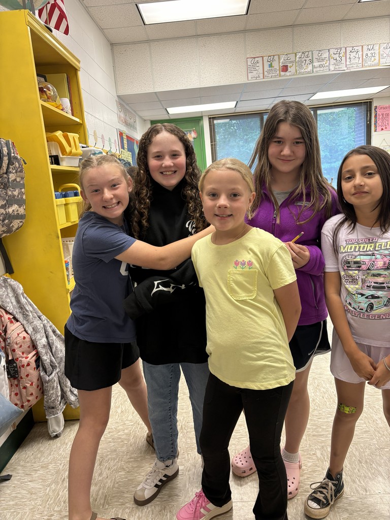 A group of girls talking to each other.