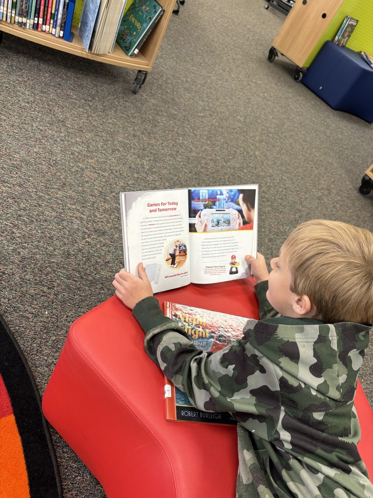 A student reading a book in the library.