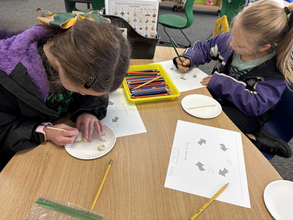 Two students in the library working on a project.