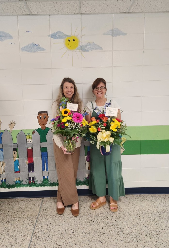 Ms. Brown and Ms. Moran holding flowers for Administrative Professionals Day.