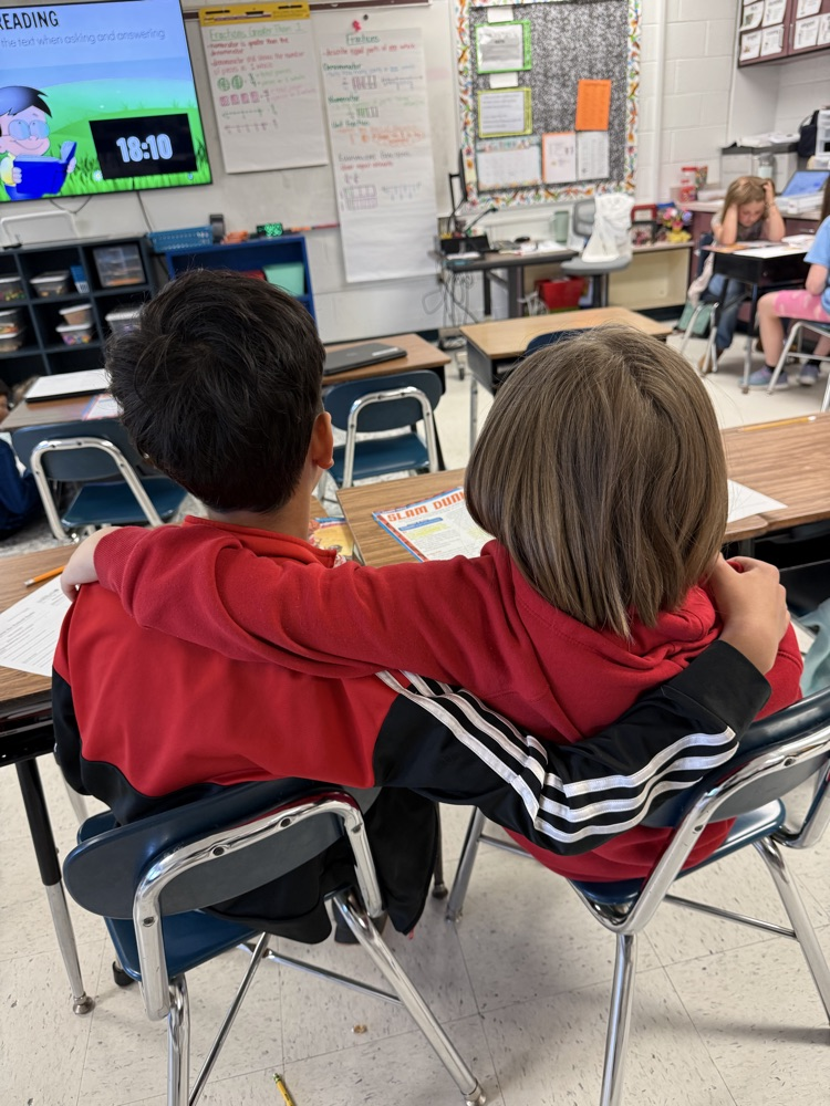 students helping each other read