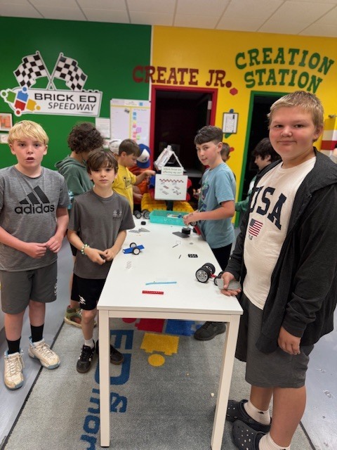 5th grade boys showing off their work at Brick Ed.