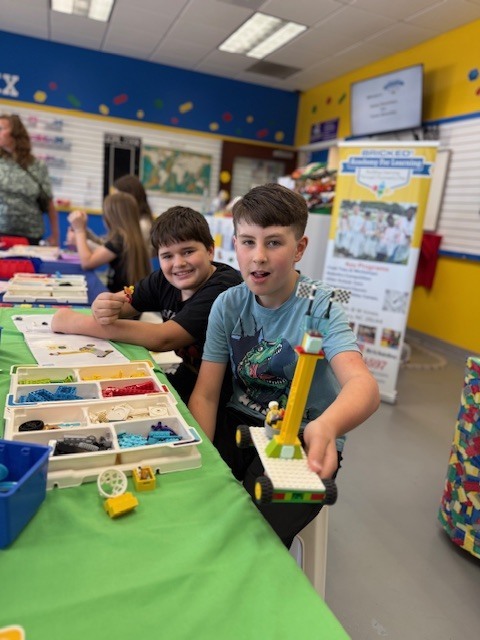 5th grade students showing off their creations at Brick Ed.