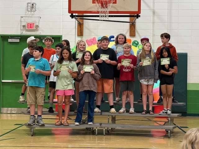 Students showing off their quarter 3 academic awards.