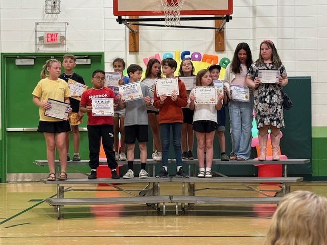 Students showing off their quarter 3 academic awards.