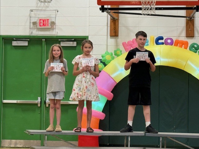 Students showing off their quarter 3 academic awards.