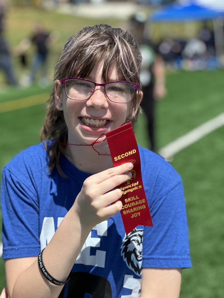 Students at special Olympics, standing on a field