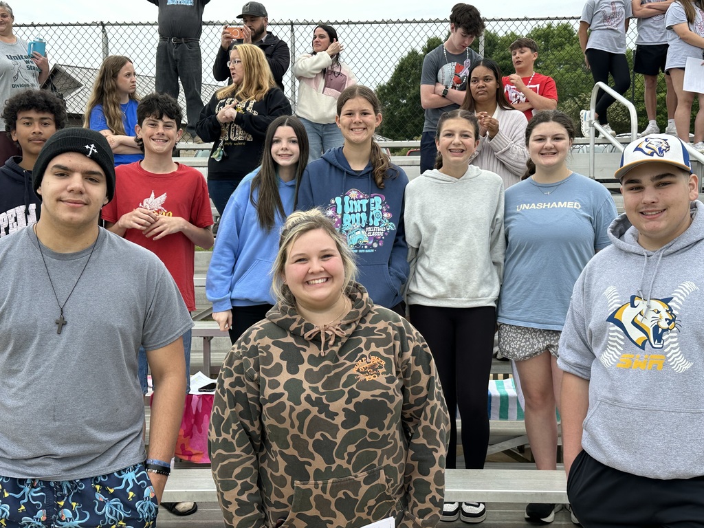 Students at special Olympics, standing on a field