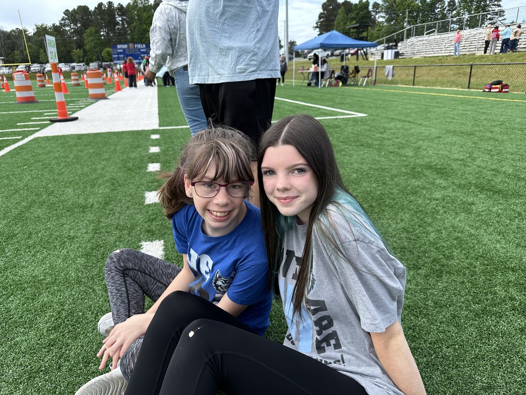 Students at special Olympics, standing on a field