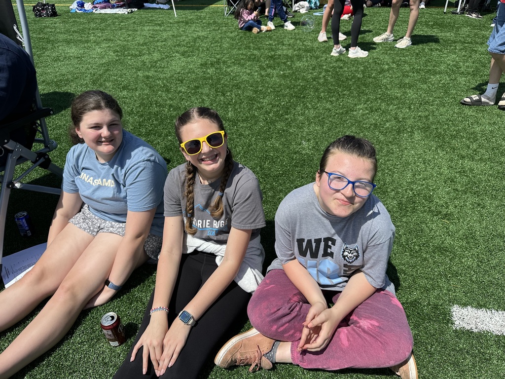 Students at special Olympics, standing on a field