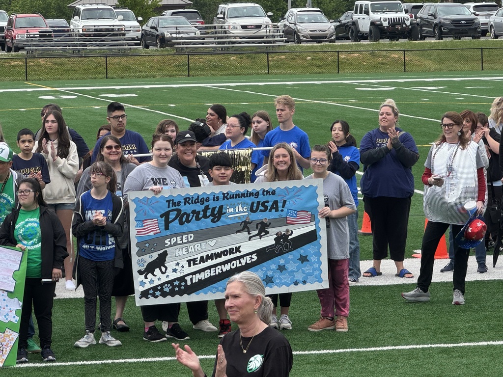 Students at special Olympics, standing on a field