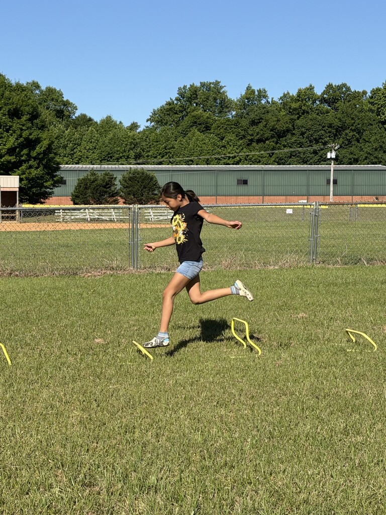 A student running over obstacles.