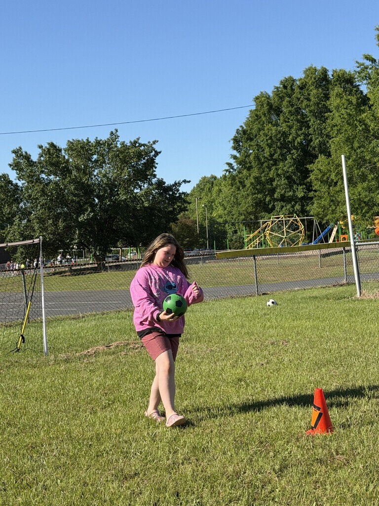 A student about to kick a soccer ball.