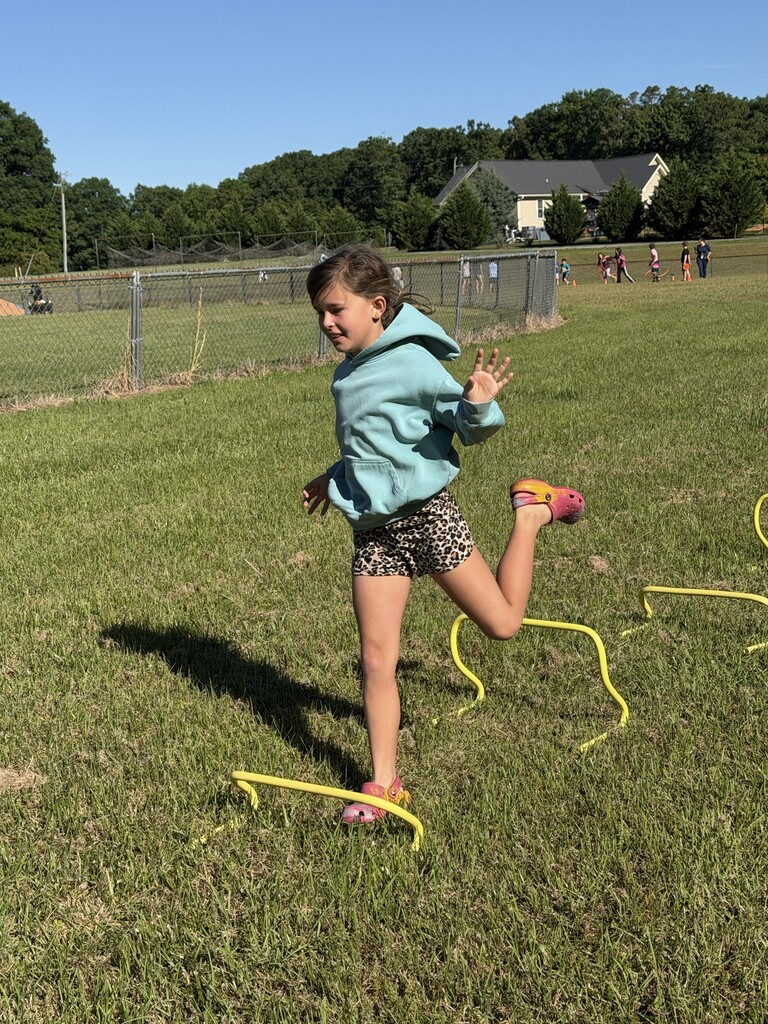 A student running over obstacles.