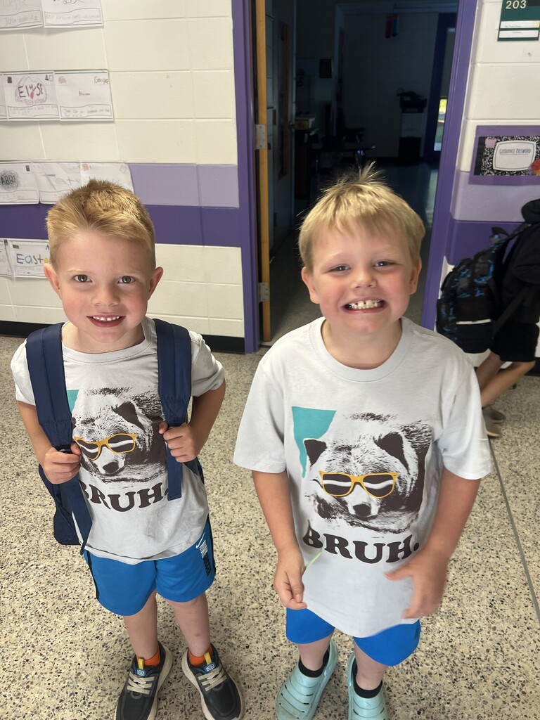 Two students excited to go out to field day in matching shirts.
