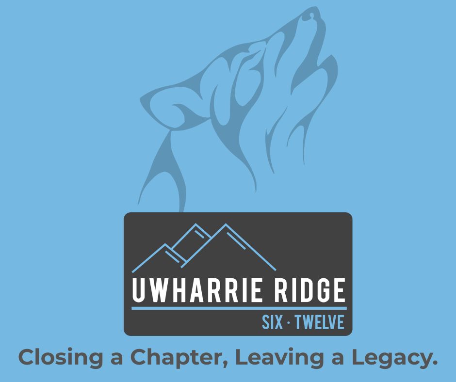 school logo with wolf howling in background