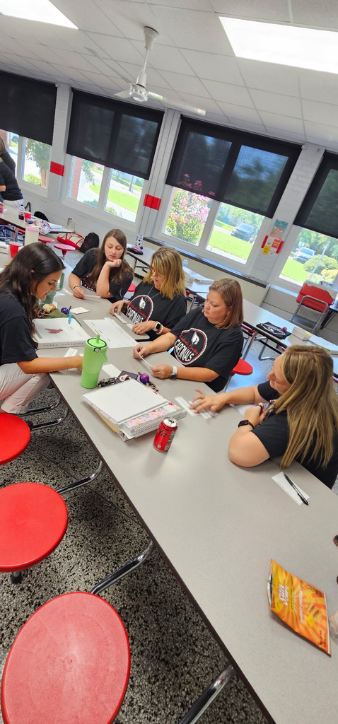 kindergarten and 1st grade teachers working together on an activity