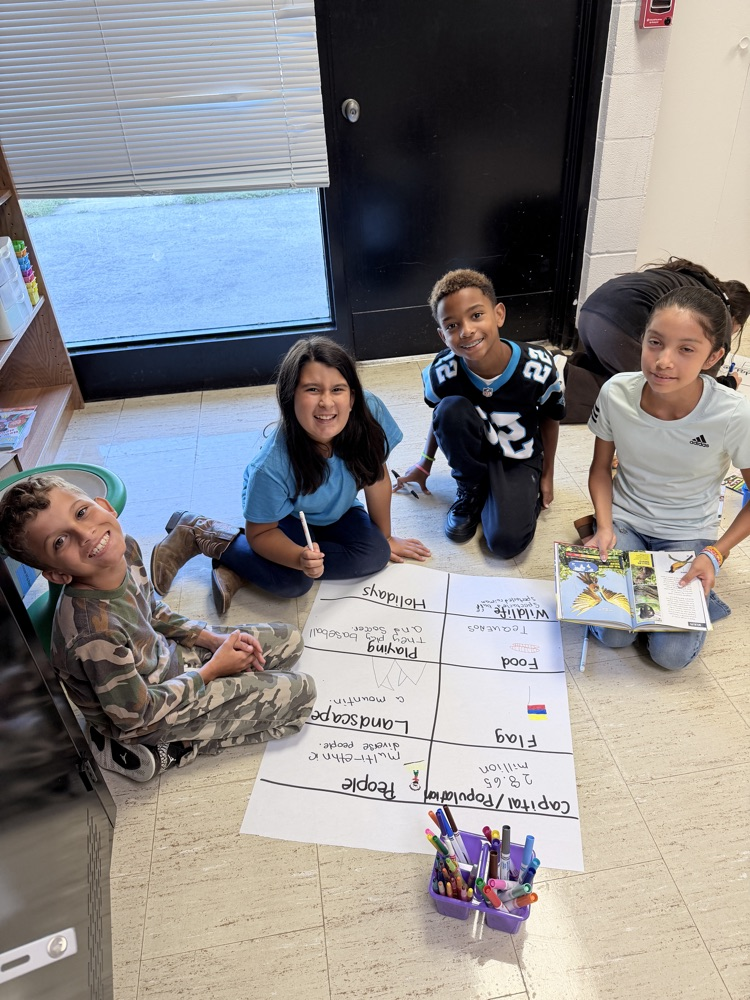 5th graders creating anchor charts for Hispanic Heritage Month