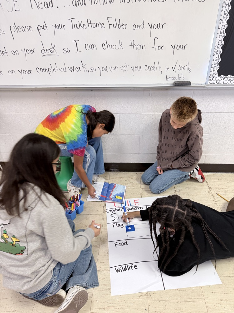 5th graders creating anchor charts for Hispanic Heritage Month