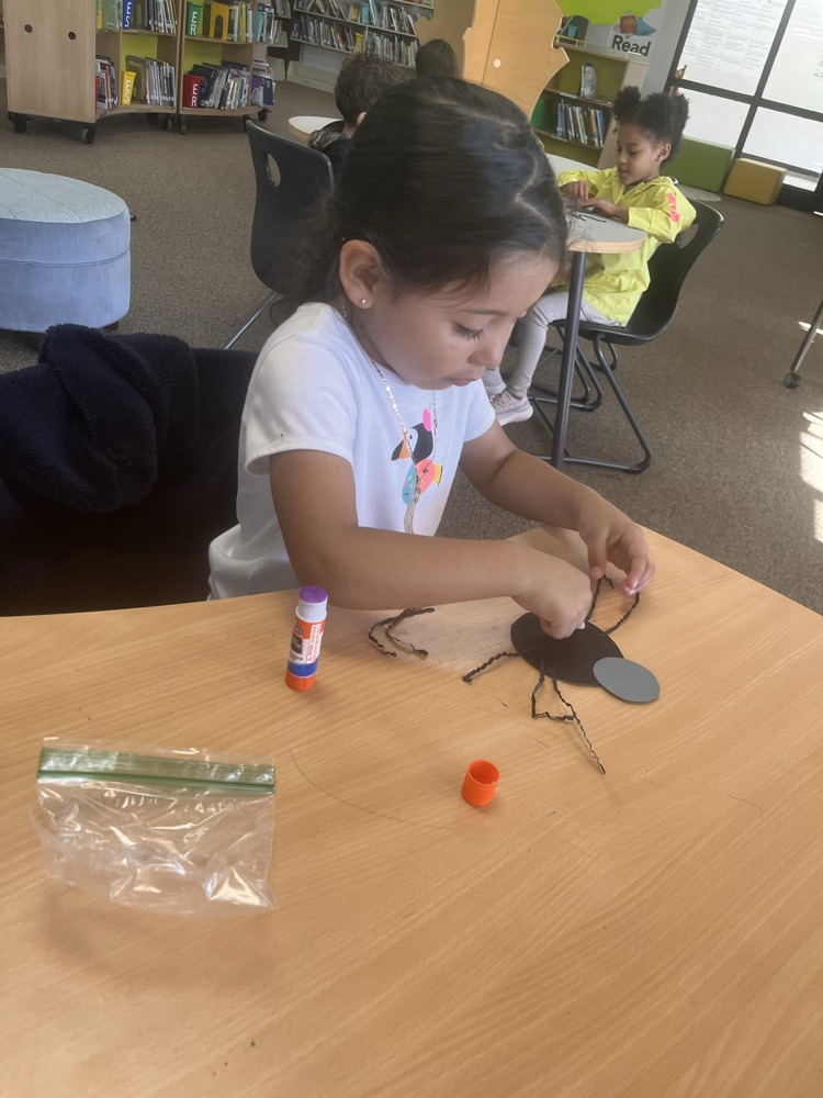 students creating spiders after listening to a story