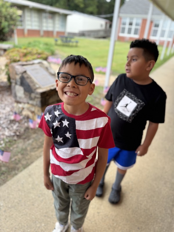 911 ceremony and students put flags in Sandy's Garden 