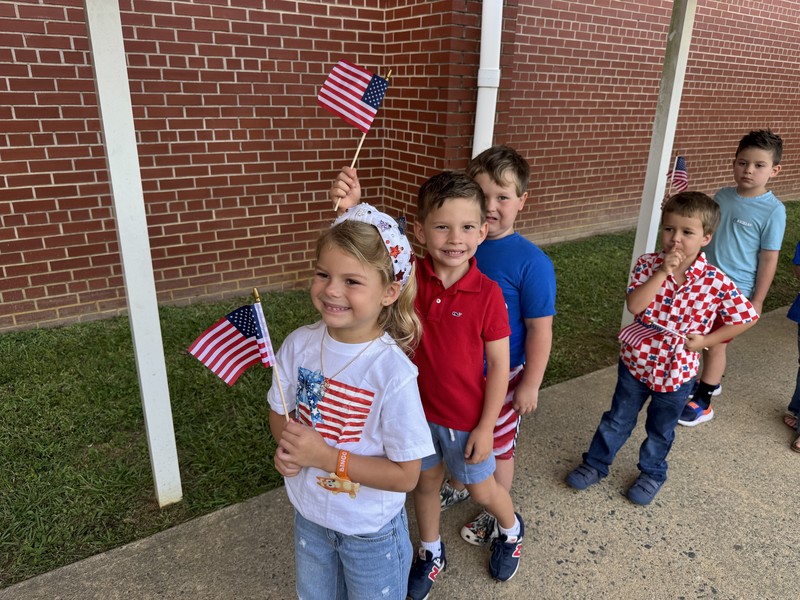 911 ceremony and students put flags in Sandy's Garden 