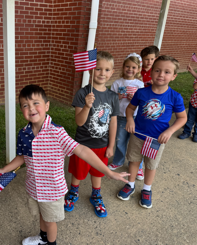 911 ceremony and students put flags in Sandy's Garden 