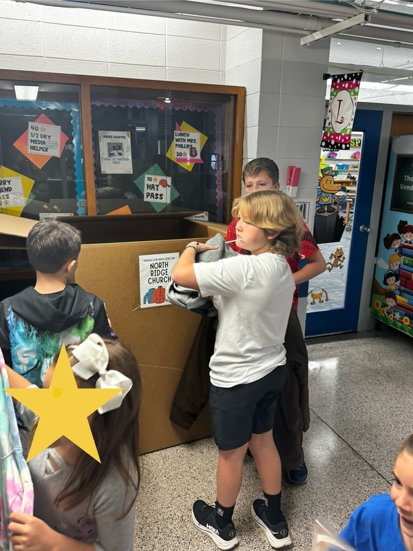 Student collecting, counting, and packing coats.