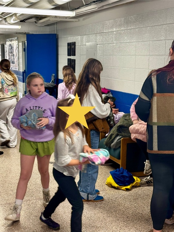 Student collecting, counting, and packing coats.
