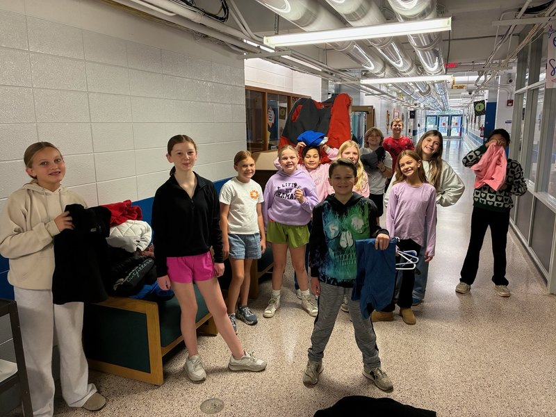 Student collecting, counting, and packing coats.