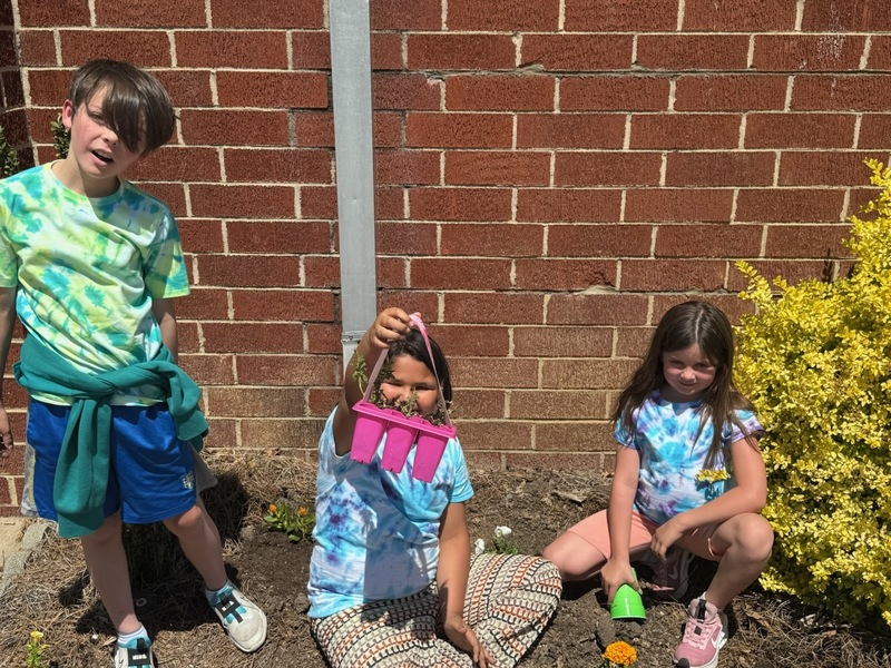 Students with their donated flowers on Earth Day.