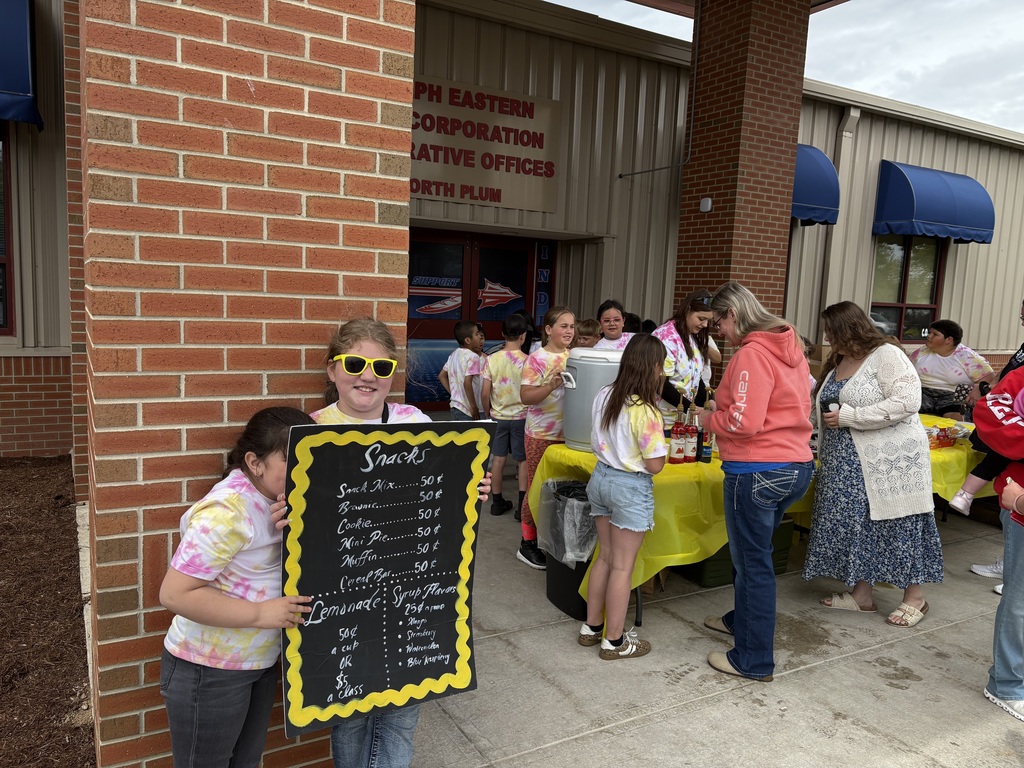 Third graders conduct business at their lemonade stand.