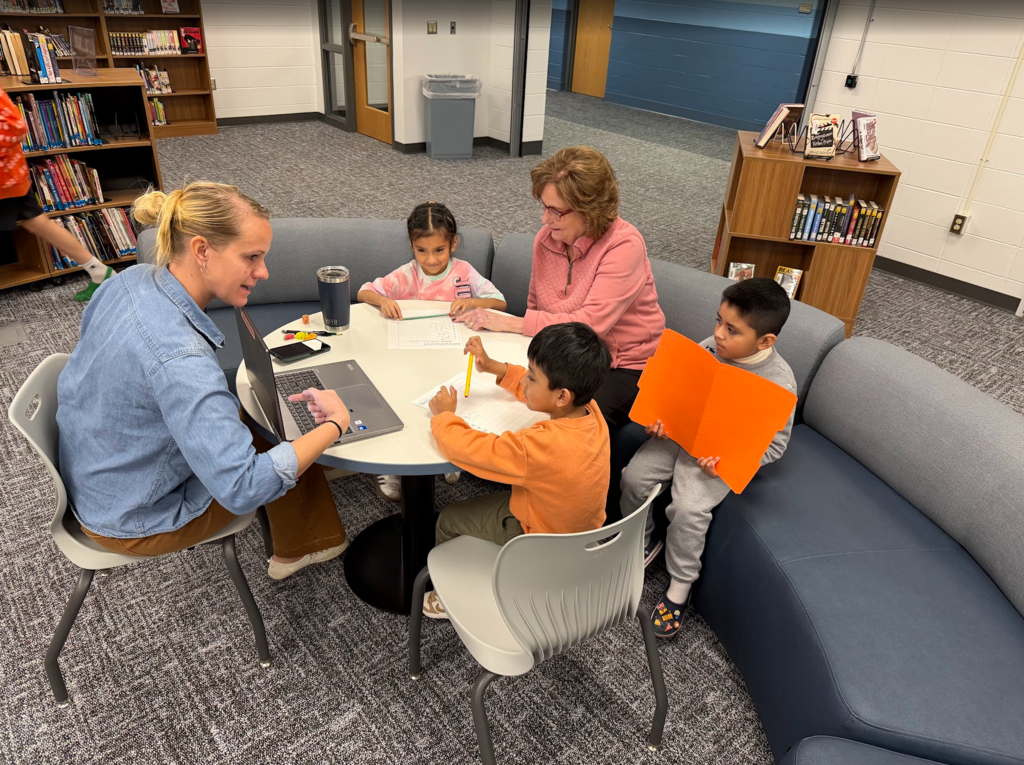 Title I Reading Specialist Aide Julie Neitzke and District ELL Support Specialist Wendy Hoffman working with some of our Kindergarten ELL students