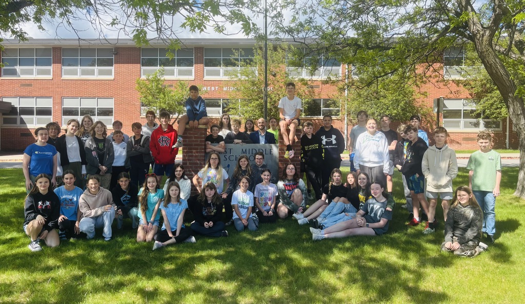 large group of students in front of west middle school all smiling as they were recognized for not have any tardies for the school year.