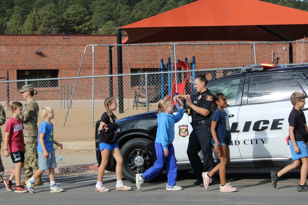 officer giving high fives