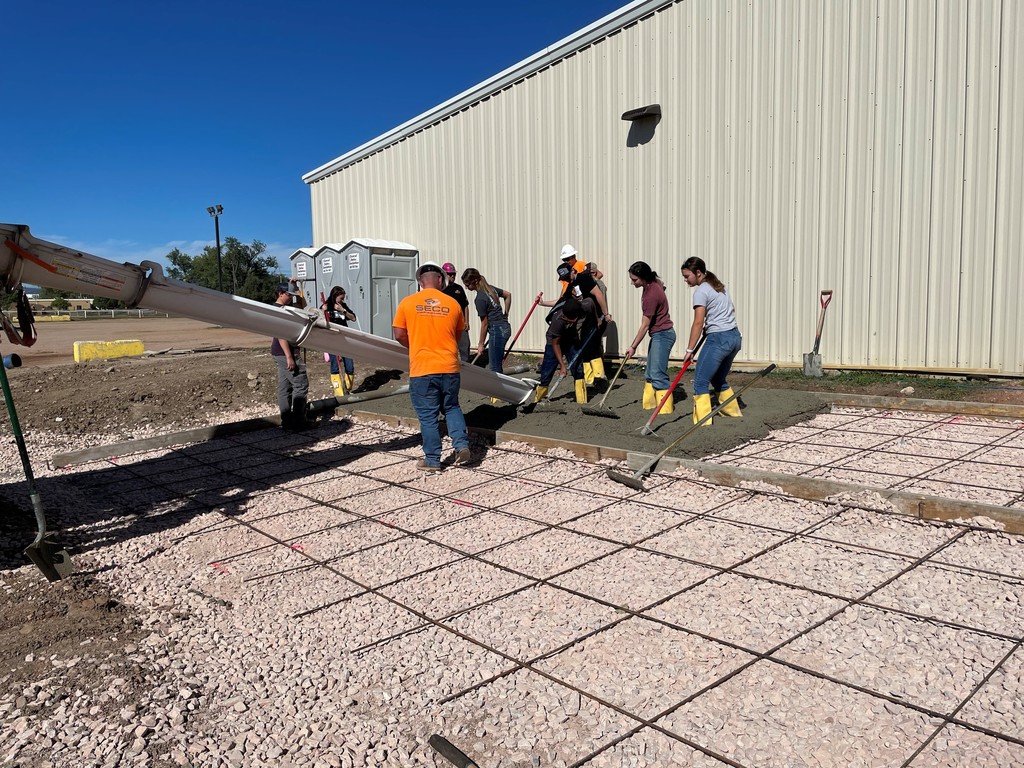 students helping with concrete 