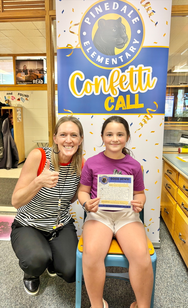 student and staff member smiling