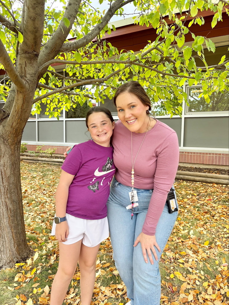 student and staff member smiling