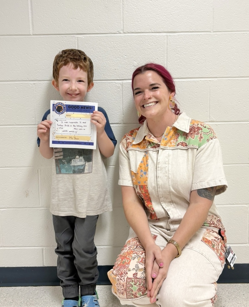 student and staff member smiling