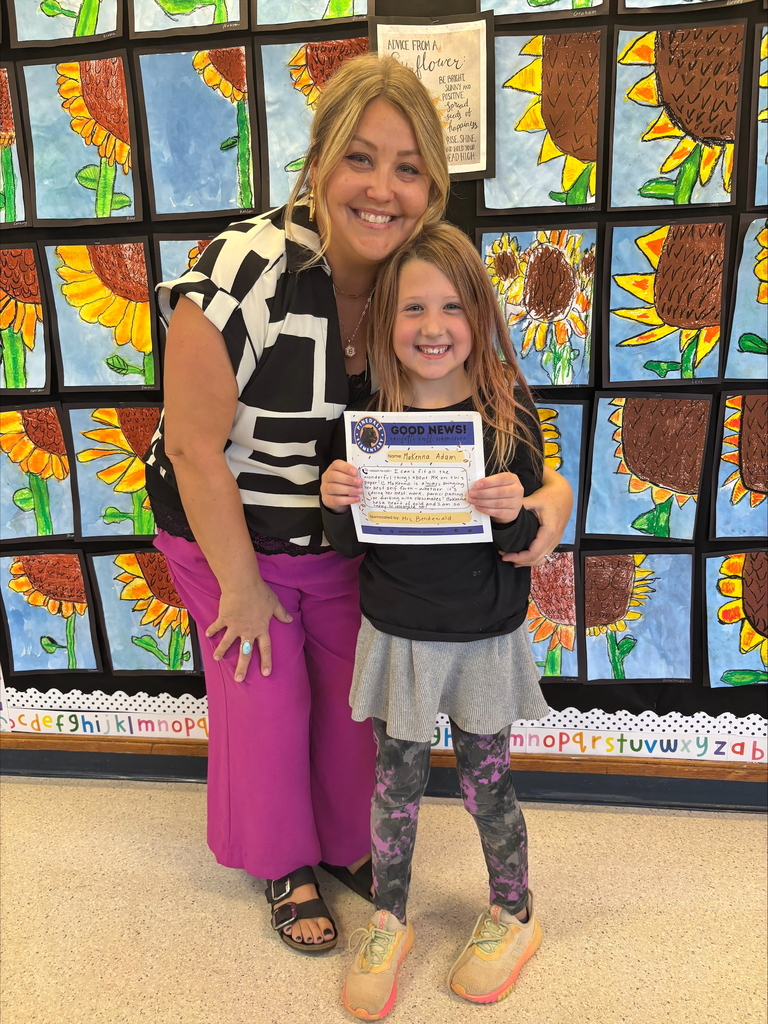 student and staff member smiling