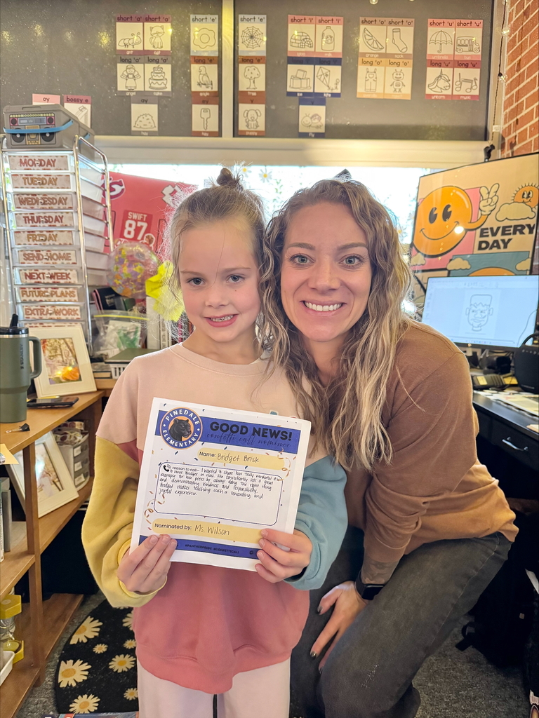 student and staff member smiling