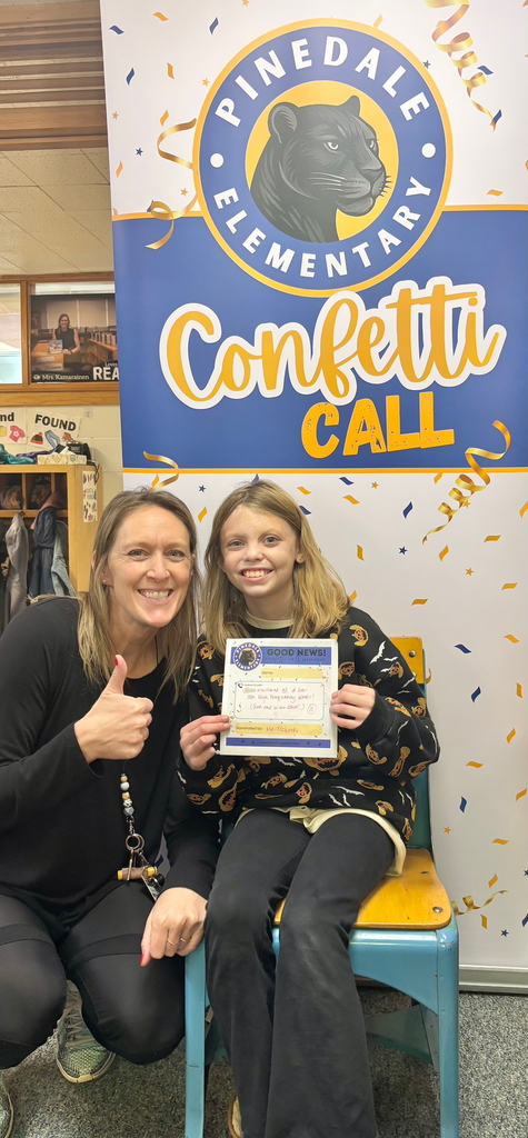 student and staff member smiling