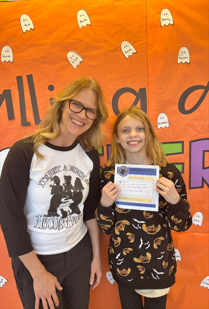 student and staff member smiling