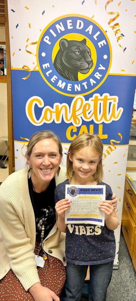 student and staff member smiling