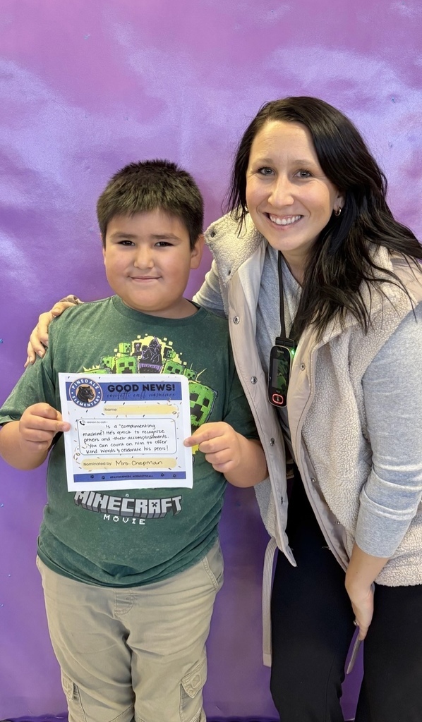 student and staff member smiling